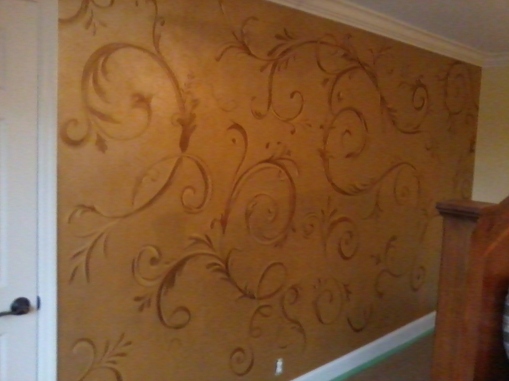 A delicate hand-painted acanthus design on an accent wall