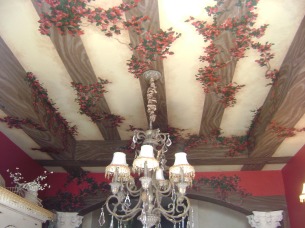 Trompe l'oeil wood beams and bougainvillea on a dining room ceiling